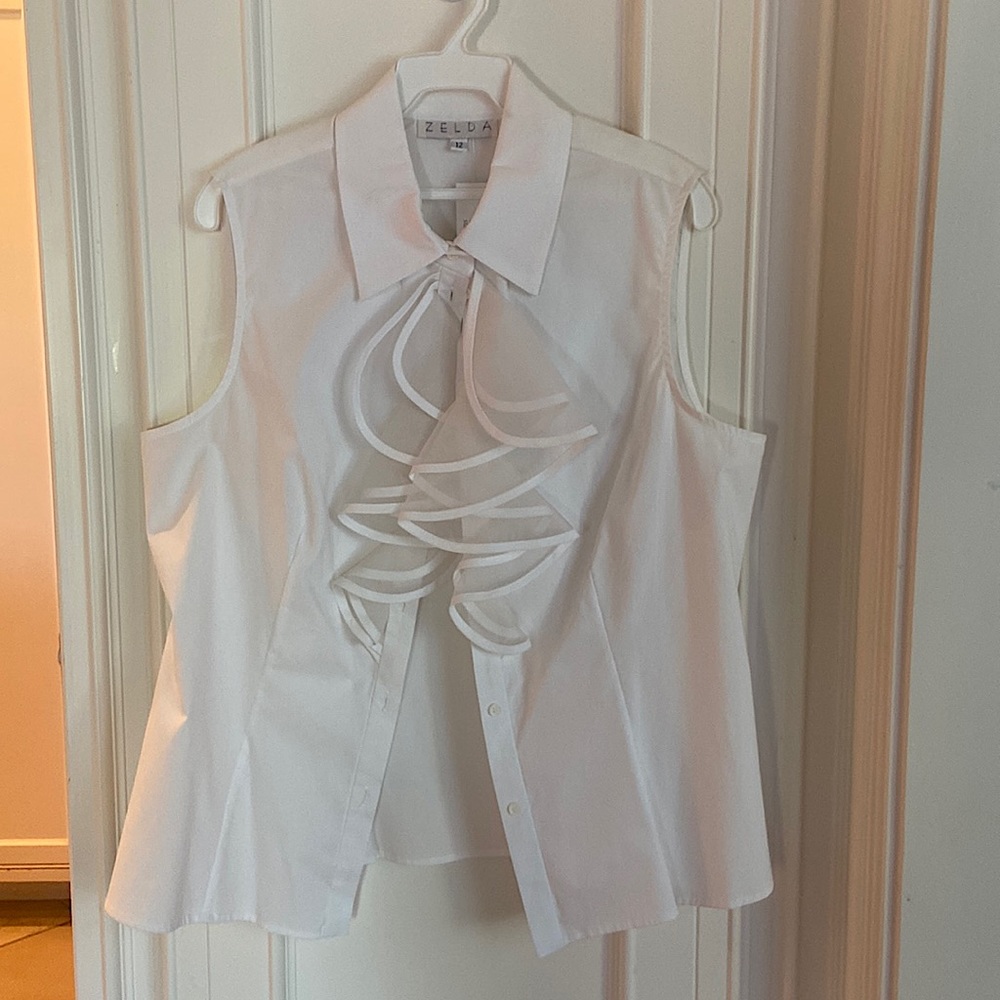Women’s sleeveless, button down top with ruffle trim. Size large in white